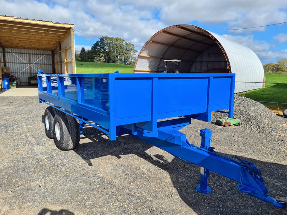 Custom blue tandem tipping trailer built by Cole Engineering