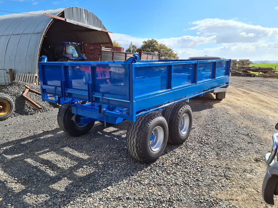 Blue tipping trailer rear three-quarter at workshop